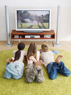 Three children watching TV